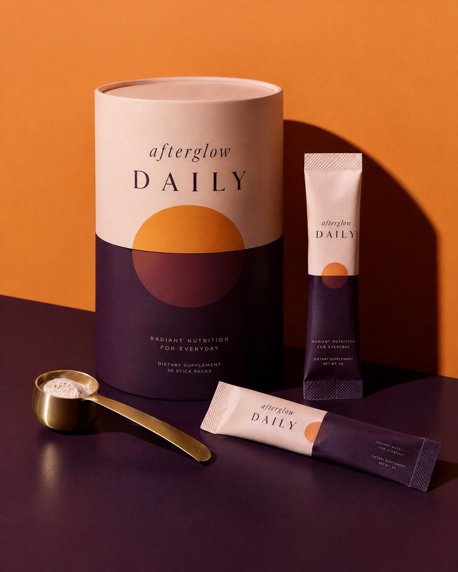 The Afterglow Daily tub with single-serve packets and a gold scoop